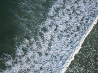 Aerial photo of waves breaking near a rural surf beach, New Zealand. 