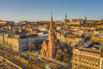 Aerial drone shot of Szilagy Dezso Square reformed church Matthias Church during Budapest sunrise