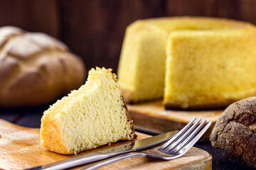 slice of Brazilian corn cake made with a type of corn flour (Fuba). Traditional homemade cake from Brazil.