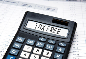 The inscription TAX FREE on the screen of the calculator against the background of the calculations.