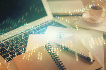 Double exposure of financial chart drawing and desktop with coffee and items on table background....