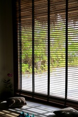 A room with a large window with blinds