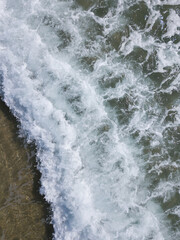 Aerial photo of waves breaking near a rural surf beach, New Zealand. 