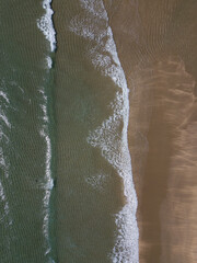 Aerial photo of waves breaking near a rural surf beach, New Zealand. 