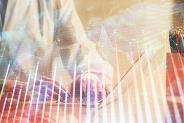 Double exposure of woman hands typing on computer and forex chart hologram drawing. Stock market invest concept.