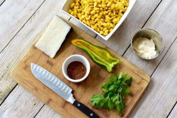 Measured and whole ingredients ready for making simple and tasty fresh street corn salad at home or in a cooking class