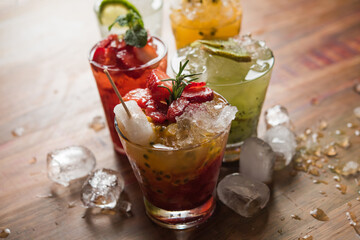 lemon, strawberry, kiwi, passion fruit caipirinhas, with ice spread