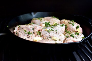 Preparing home made family recipe fried chicken with fresh organic herbs of thyme, sage, rosemary and butter for summer picnic outdoor dinner
