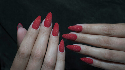 red long nail manicure on dark background