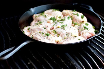 Preparing home made family recipe fried chicken with fresh organic herbs of thyme, sage, rosemary and butter for summer picnic outdoor dinner