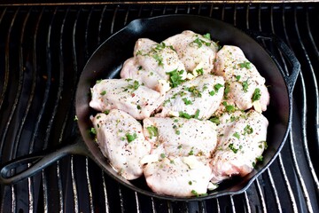 Preparing home made family recipe fried chicken with fresh organic herbs of thyme, sage, rosemary and butter for summer picnic outdoor dinner