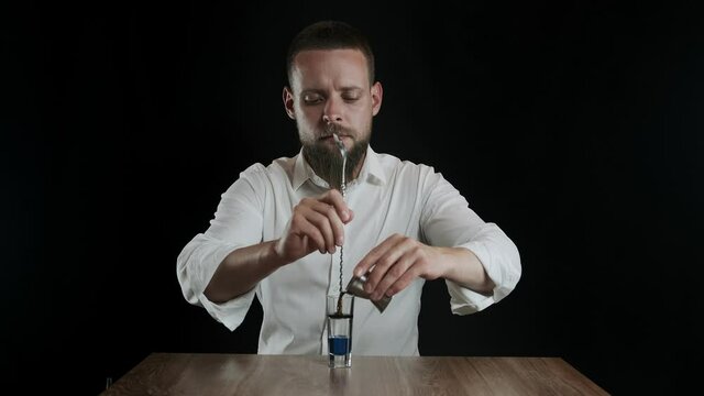 Preparing of Lexus Cocktail. Bartender pouring coffee liquor into a glass