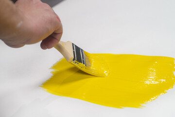 Brushes with colored paint on a black background. Tools for repair.