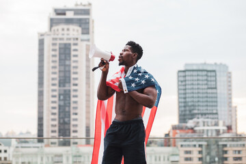 black lives matter concept. Aggressive african american guy with usa flag protests and shouts, patriot activist of america makes rebellion