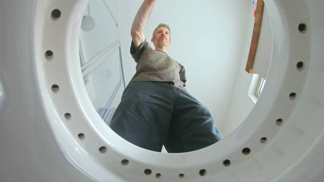 A pov view from inside the toilet with water flushing down