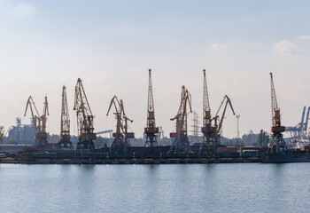 Fototapeta na wymiar harbor cranes in sunny weather