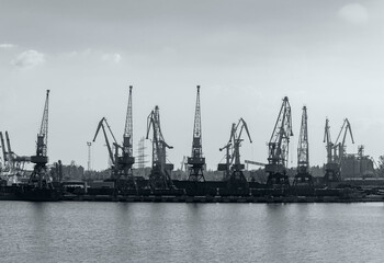 Fototapeta premium Harbor cranes, black and white poster