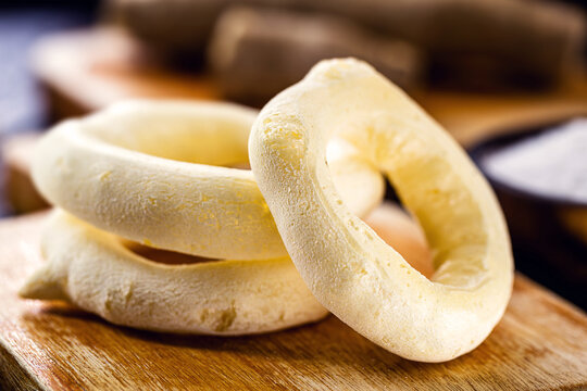 Traditional Brazilian starch biscuit called polvilho biscuit, on wooden table