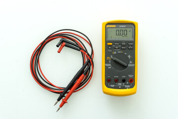 Yellow Digital multimeter with probes for measuring voltage, current, resistance on white background , A multimeter is an electronic measuring instrument.	
