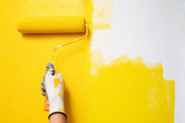 Roller Brush Painting, Worker painting on surface wall  Painting apartment, renovating with yellow...