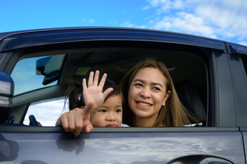 happy little girl with family sitting in the car.Car insurance concept