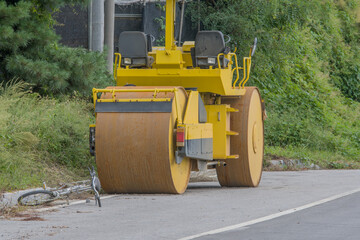 Bicycle in front of road roller.