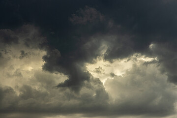 Naklejka na ściany i meble Dark and gloomy clouds before a monsoon thunderstorm. 