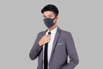 Portrait young asian businessman in suit wearing face mask for protective covid-19 isolated on white background, business man hand holding neck tie, quarantine for pandemic coronavirus, new normal.