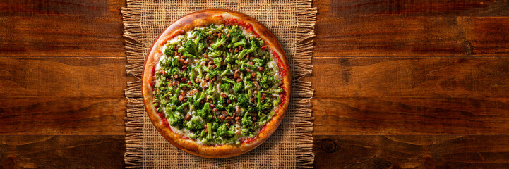 Pizza Broccoli and bacon on wood background. Top view, close up. Traditional Brazilian Pizza