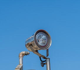 Searchlight mounted on metal pole