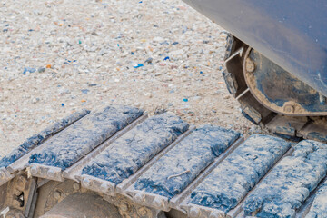 Worn rubber pads on metal backhoe track
