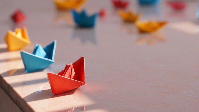 Colorful paper boats, homemade handicrafts, children's toys, blur background