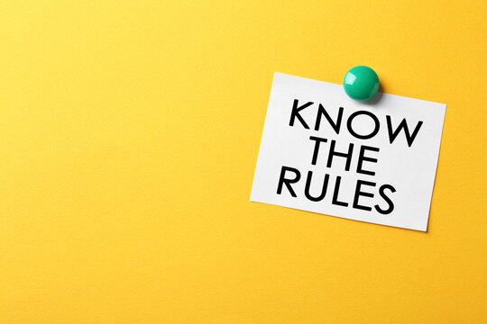 Paper note with phrase Know the rules on yellow background, space for text