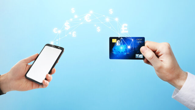 Fintech concept. Man using phone to make financial transactions with credit card