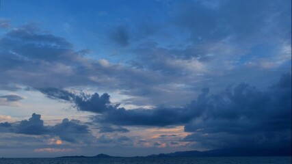 Naklejka na ściany i meble Rain storm sky with clouds moving above the seascape