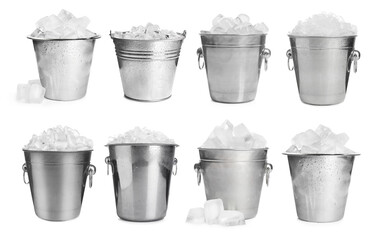 Set of different metal buckets with ice cubes on white background