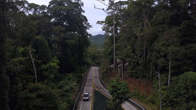 Flying Overhead Jeep Riding At Asphalt Road In Beautiful Lush Green Jungle Forest At Tropical Island Of Koh Phangan, Thailand