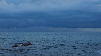 Rain storm sky with clouds moving  above the seascape