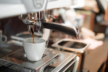 black coffee in white cup put on coffee maker