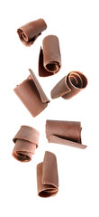 Set with yummy chocolate curls falling on white background