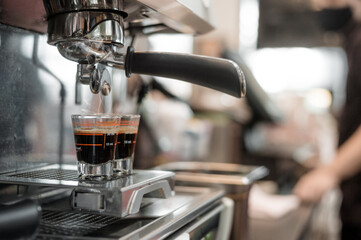 black coffee in measuring cup put on coffee maker