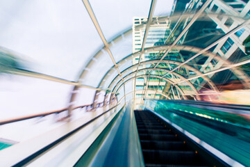 Abstract motion blurred view through an escalator tunnel