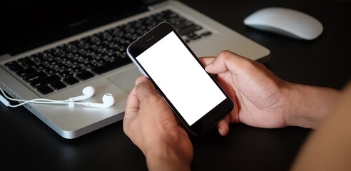 Cropped shot view of man hands holding smart phone with blank copy space screen for your text message or information content, female reading text message on cell telephone during in urban setting. 