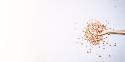 Top view of crop grain in wooden spoon, copy space