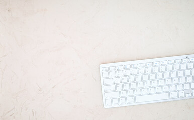 On large white background with bottom edge lies  keyboard and free space