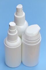 Plastic white  bottles Mockup. Cosmetic bottles set on a light blue background. Beauty and health tools concept.Hand disinfector .Household chemicals and cosmetics white bottles.