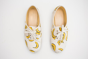 Banana striped shoes on white background