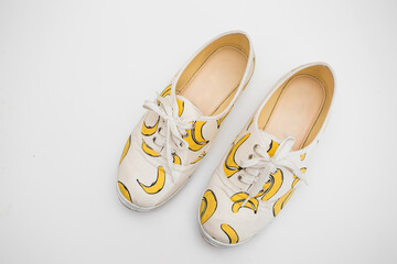 Banana striped shoes on white background