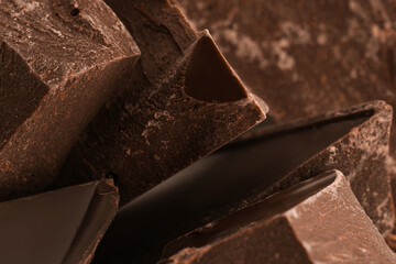 Pieces of dark chocolate as background, closeup