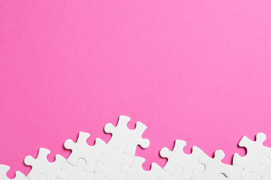 Blank white puzzle pieces on pink background, flat lay. Space for text  Stock-Foto | Adobe Stock